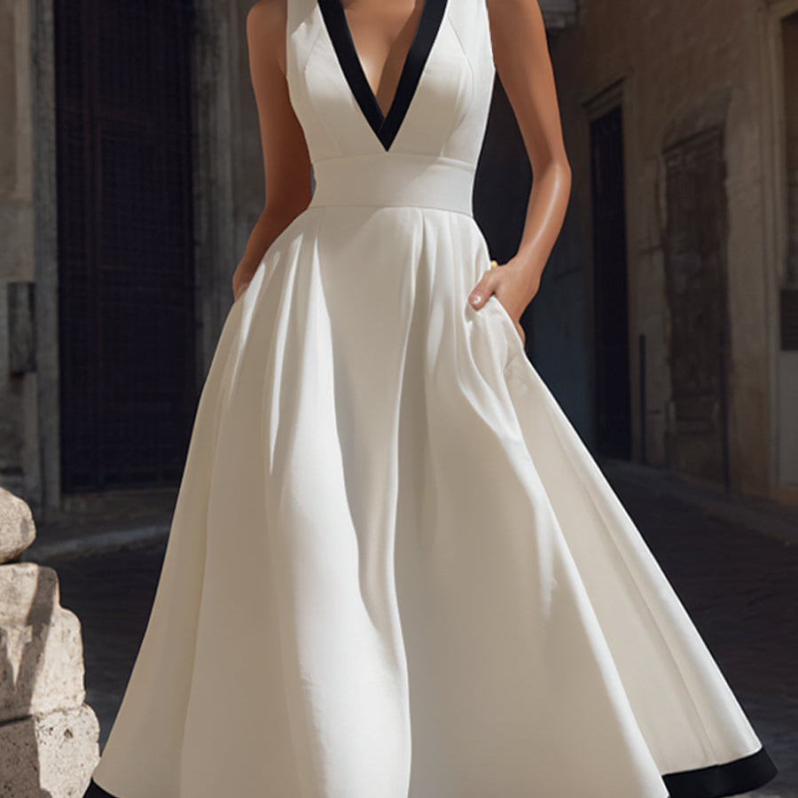 Elegancka sukienka midi w kształcie litery A z dekoltem w serek, kontrastowym wykończeniem i kieszeniami